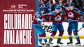 Colorado Avalanche players celebrate beside a KeyBank advertisement.
