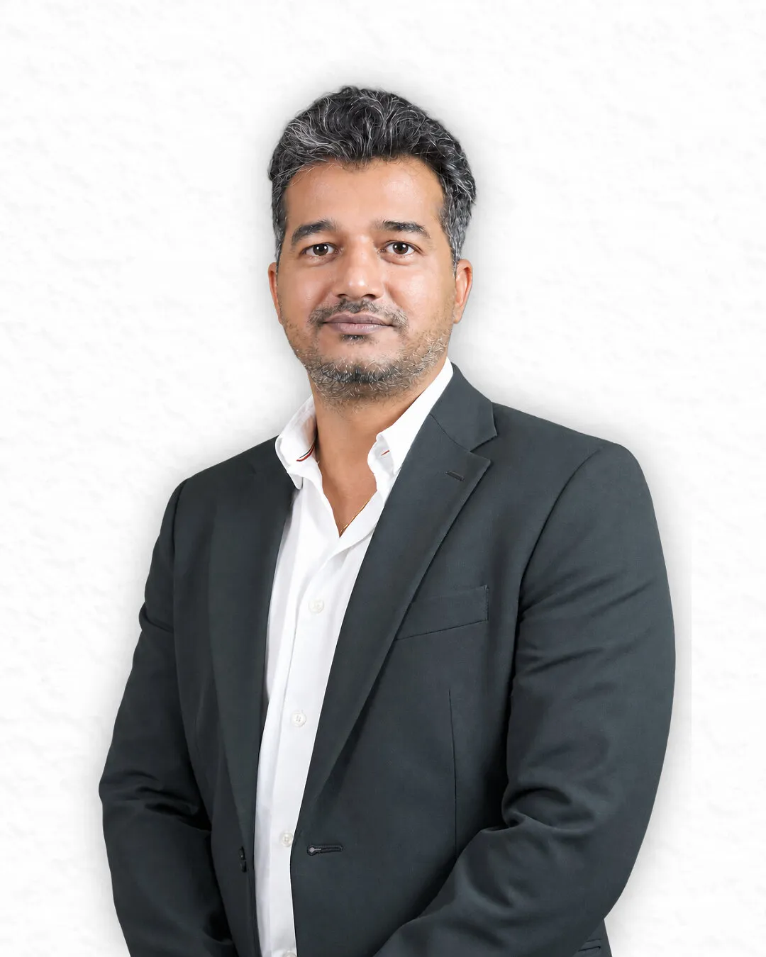 Mayur Kapse in a dark suit jacket and white shirt against a light background.