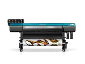 Large-format printer with ink cartridges and a roll of colorful motorsport decals.