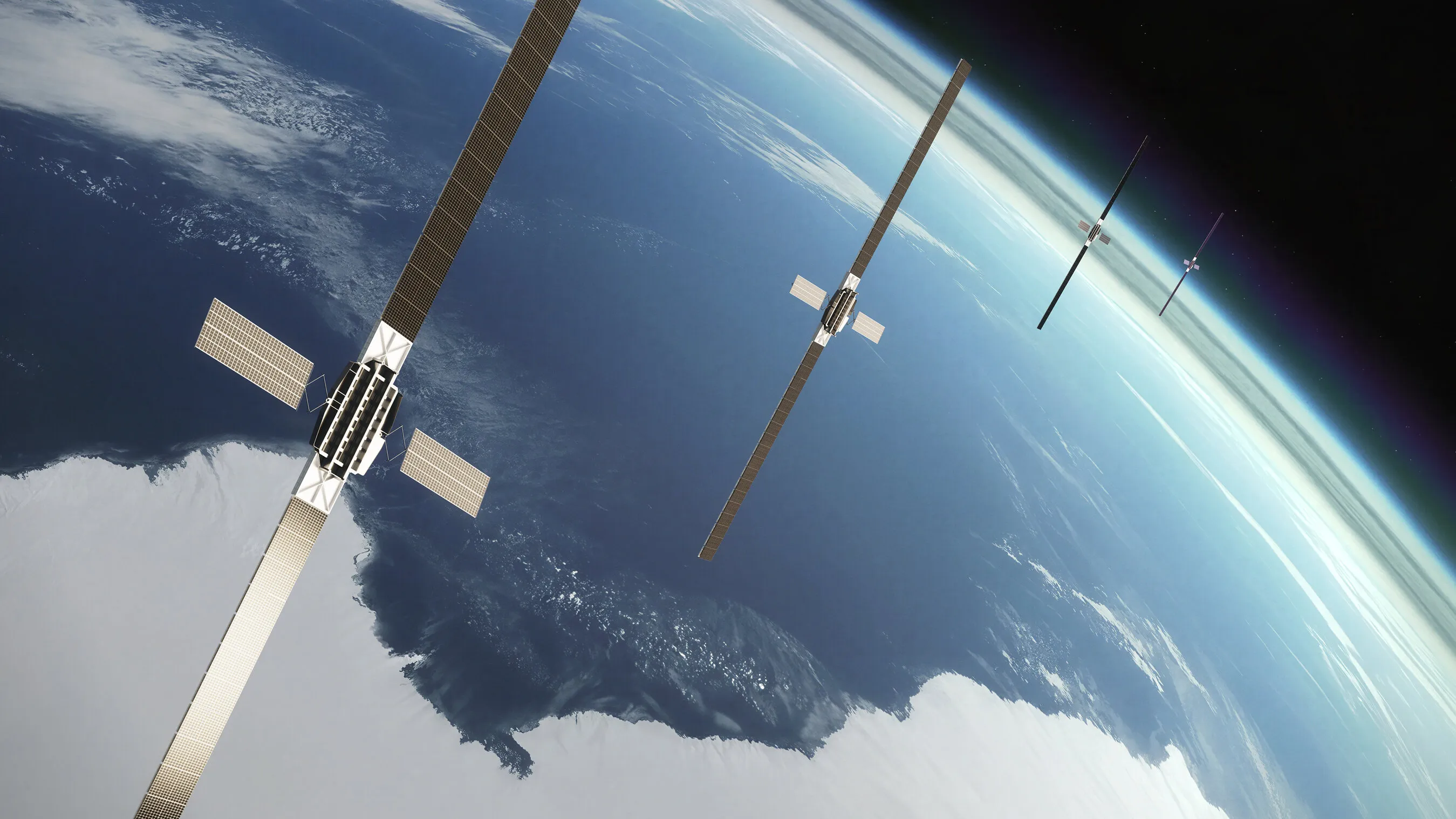 Four satellites with solar panels orbiting above Earth.