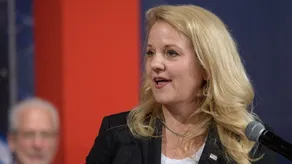 Gwynne Shotwell, president and chief operating officer of SpaceX, speaking at a microphone at a NASA event in Houston in 2018