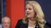 Gwynne Shotwell, president and chief operating officer of SpaceX, speaking at a microphone at a NASA event in Houston in 2018